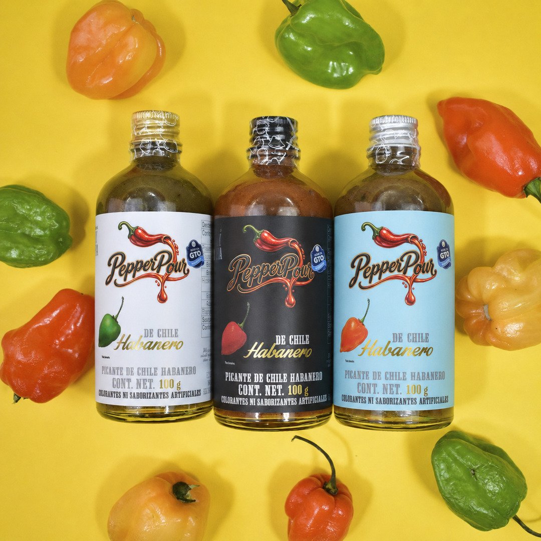 Three PepperPour sauces with fresh habanero peppers